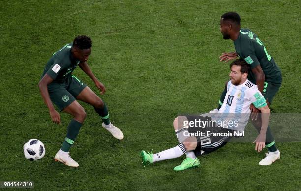 Lionel Messi of Argentina is tackled by Bryan Idowu of Nigeria during the 2018 FIFA World Cup Russia group D match between Nigeria and Argentina at...