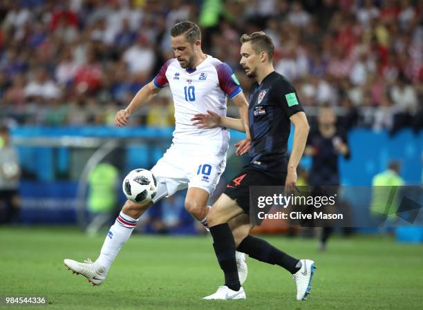 Gylfi Sigurdsson of Iceland is challenged by Filip Bradaric of Croatia during the 2018 FIFA World Cup Russia group D match between Iceland and...