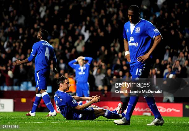 Phil Jagielka of Everton reacts after scoring an own goal during the Barclays Premier League match between Aston Villa and Everton at Villa Park on...