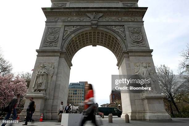 Pedestrian passes the arch at Washington Square Park in New York, U.S., on Monday, April 5, 2010. New York University will face financial hurdles and...