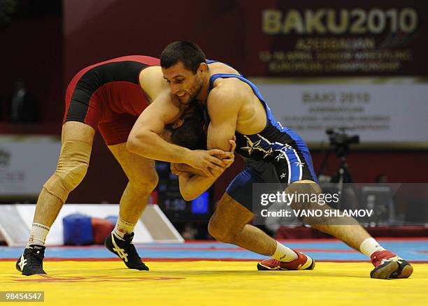 Otar Tushishvili of Georgia competes with Ismail Emin Redzhep of Bulgaria during the bronze medal fight for Free Style 66 kg category at the European...