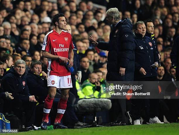 Manager of Arsenal Arsene Wenger speaks to Robin Van Persie before bringing him on during the Barclays Premier League match between Tottenham Hotspur...