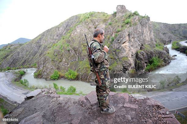 Village guard stands with his rifle on April 10, 2010 in the mountainous southeastern city of Siirt. The village guards, made up of Kurdish peasants...