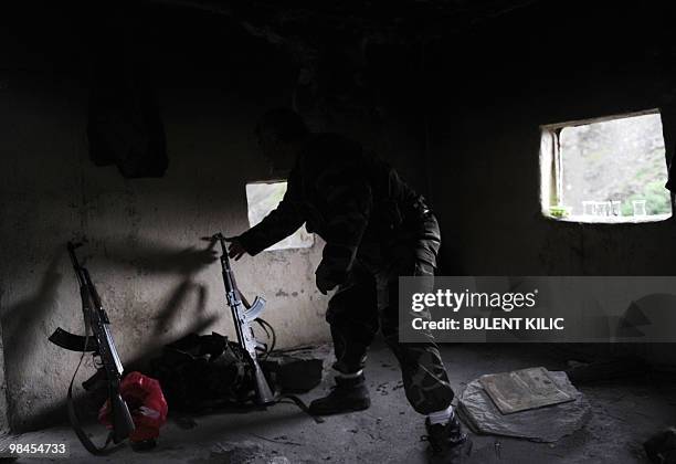 Village guard take his rifle after resting in his cabin on April 10 in the mountainous southeastern city of Siirt. The village guards, made up of...