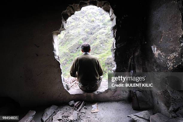 Village guard sits at the entrance to his cabin on April 10, 2010 in the mountainous southeastern city of Siirt. The village guards, made up of...