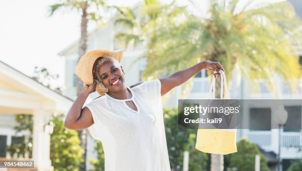 senior african-american woman standing on pool deck - wide brim stock pictures, royalty-free photos & images