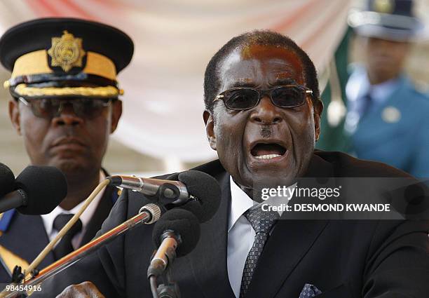 In this file picture taken on January 18, 2010 Zimbabwean President Robert Mugabe gives a speech during the burial of Sunny Ntombiyelanga Takawira,...