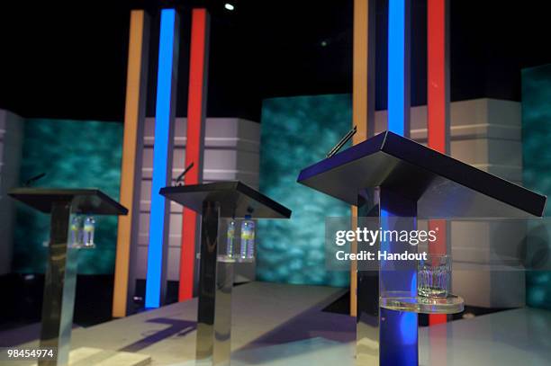 In this handout image provided by ITV1, Glasses of water sit next to three speakers' stands as the stage is prepared for the first televised general...