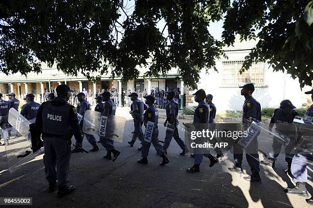 Police move into position in front of the Ventersdorp's court on April 14, 2010. The accused murderers of South African white supremacist Eugene...