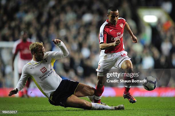 Theo Walcott of Arsenal is challenged by Eidur Gudjohnsen of Tottenham Hotspur during the Barclays Premier League match between Tottenham Hotspur and...