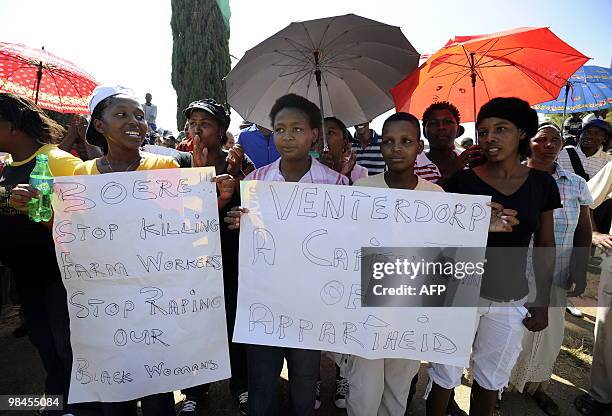 People demonstrate on April 14, 2010 outside the Ventersdorp courthouse. The court on April 14 extended the detention of two farmworkers accused of...