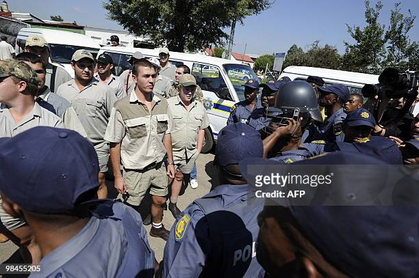 Some Afrikaners, supporters of the AWB, arrive on April 14, 2010 outside the Ventersdorp courthouse where police blocked their access to the main...