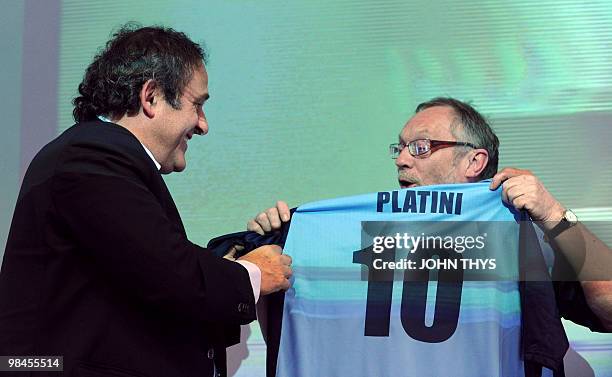 President Michel Platini receives a Sheffield FC jersey from Peter Moore , advisor of the city of Sheffield and sport and social integration...