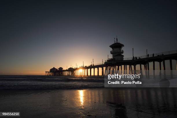 sunset huntington beach pier - polla stock pictures, royalty-free photos & images