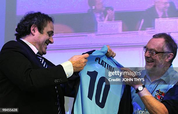 President Michel Platini receives a Sheffield FC jersey from Peter Moore , advisor of the city of Sheffield and sport and social integration...