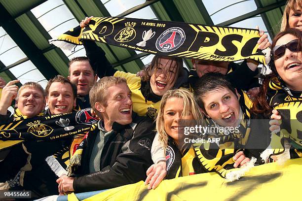 Supporters of French Fourth division Quevilly football club pose with a scarf on April 14, 2010 in Caen, northwestern France, before attending the...