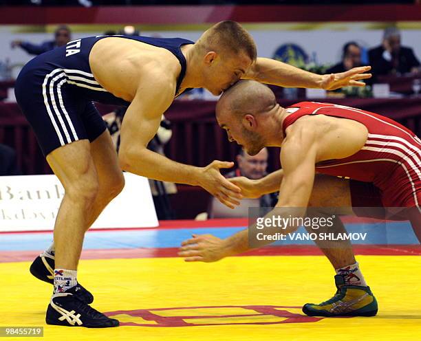 Jukka Iimari Hyytiainen of Finland competes with Andrey Prepelita of Moldova during the Freestyle Wrestling 60kg bronze medal match at the Senior...