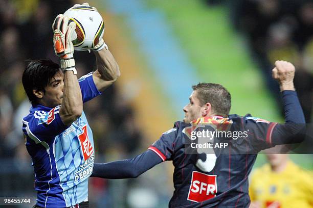 Quevilly's goalkeeper Hicham Rhoufir grabs the ball in front of Paris' Sylvain Armand during their French Cup football match Quevilly vs Paris...