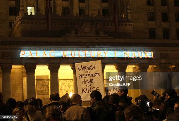 Group of people attends a protest demanding not to burry the late Polish presidential couple in Cracow's Wawel castle, in front of the Palace of...