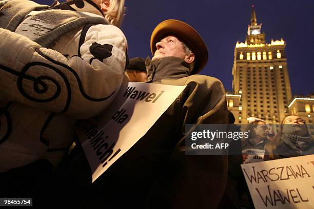Group of people attends a protest demanding not to burry the late Polish presidential couple in Cracow's Wawel castle, in front of the Palace of...