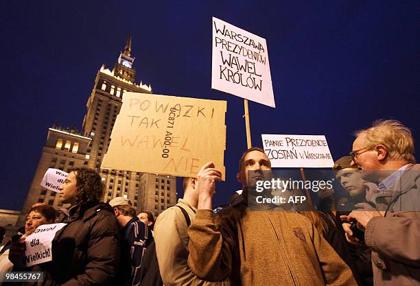 Group of people attends a protest demanding not to burry the late Polish presidential couple in Cracow's Wawel castle, in front of the Palace of...