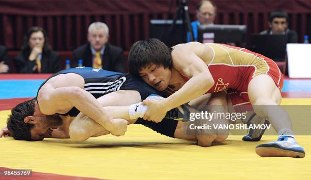 Opan Sat of Russia competes with Malkhaz Zarkia of Georgia during the Freestyle Wrestling 60kg gold medal match at the Senior Wrestling European...