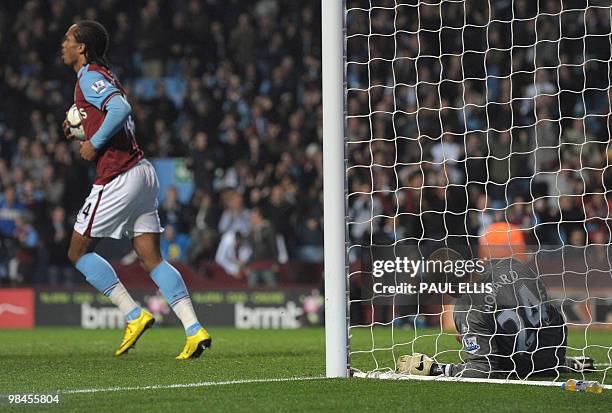 Everton's American goalkeeper Tim Howard reacts after conceeding to an own goal during injury time of their English Premier League football match...