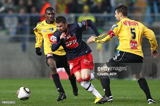 Paris' forward Mateja Kenzam vies with Quevilly's midfielder Fodie Traore and defender Gregory Beaugrard during their French Cup football match...
