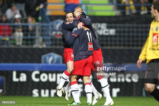Paris' forward Mevlut Erding celebrates with teammates after scoring a goal during their French Cup football match Quevilly vs Paris Saint-Germain on...