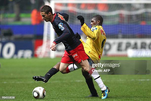 Quevilly's midfielder Fodie Traore vies with Paris's midfielder Jeremy Clement during their French Cup football match Quevilly vs Paris Saint-Germain...