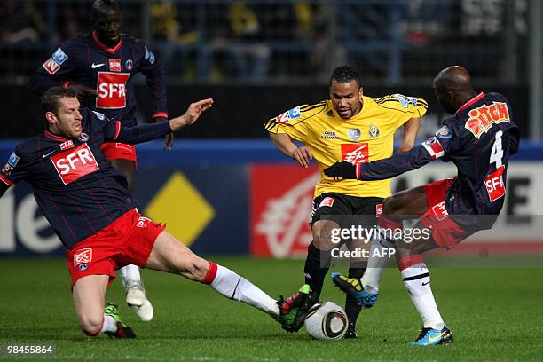 Quevilly's Anthony Laup vies with Paris' Sylvain Armand and Claude Makele during their French Cup football match Quevilly vs Paris Saint-Germain on...