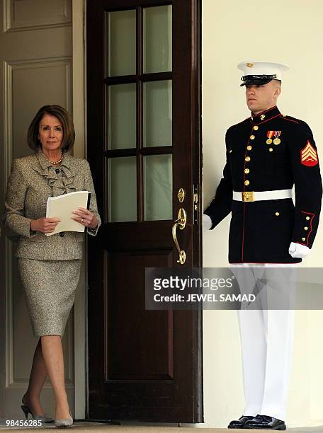 House Speaker Nancy Pelosi holding a copy of "The Economic Impact of the American Recovery and Reinvestment Act" arrives to speaks to reporters...