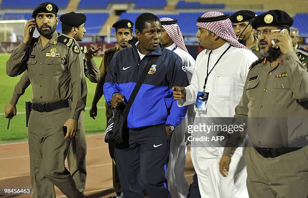 Saudi security forces and organisers escort an assistant coach for Uzbekistan's Bunyodkor following clashes with the referee and his assistants at...