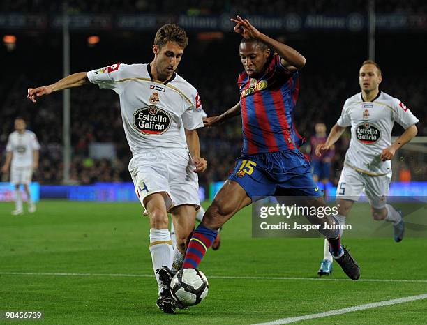 Seydou Keita of FC Barcelona duels for the ball with Adrian Lopez of Deportivo la Coruna during the La Liga match between Barcelona and Deportivo La...