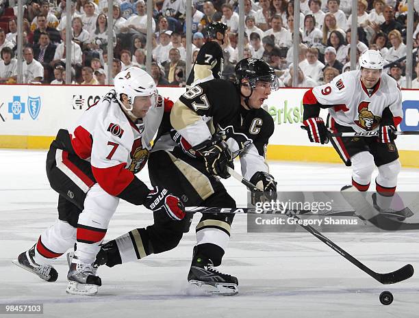 Sidney Crosby of the Pittsburgh Penguins moves the puck up ice ahead of Matt Cullen of the Ottawa Senators in Game One of the Eastern Conference...