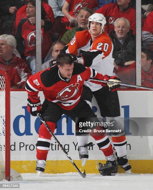 Chris Pronger of the Philadelphia Flyers hits Zach Parise of the New Jersey Devils in Game One of the Eastern Conference Quarterfinals during the...