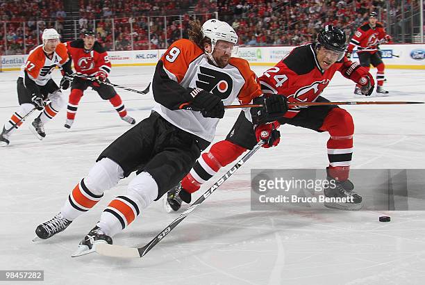 Bryce Salvador of the New Jersey Devils takes a two minute penalty for tripping Scott Hartnell of the Philadelphia Flyers during the first period in...