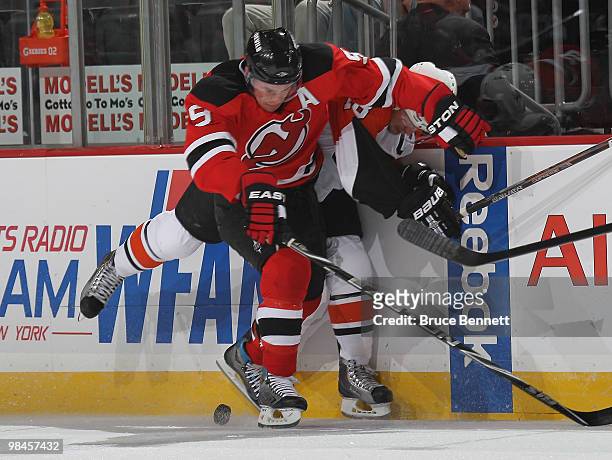 Mike Richards of the Philadelphia Flyers is boarded by Zach Parise of the New Jersey Devils in Game One of the Eastern Conference Quarterfinals...