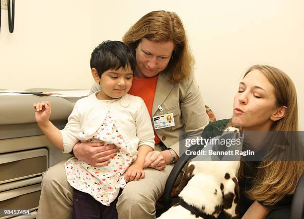 Patient Emily Santana, Nurse Practioner, head dog trainer Melissa Harris with Gracie the Dalmatian of '101 Dalmatians' the Musical during Gracie's...