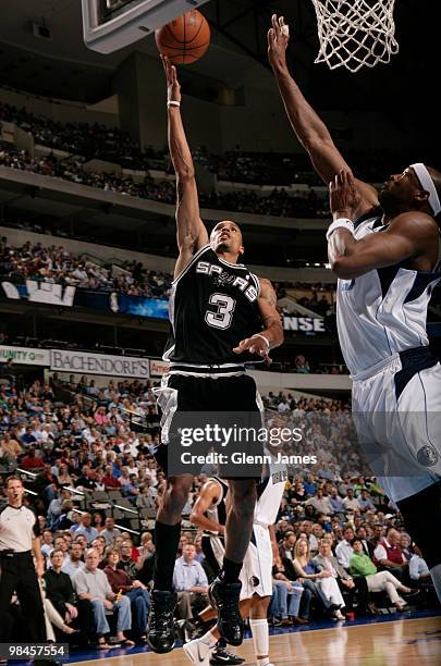 George Hill of the San Antonio Spurs goes in for the layup against Erick Dampier of the Dallas Mavericks during a game at the American Airlines...