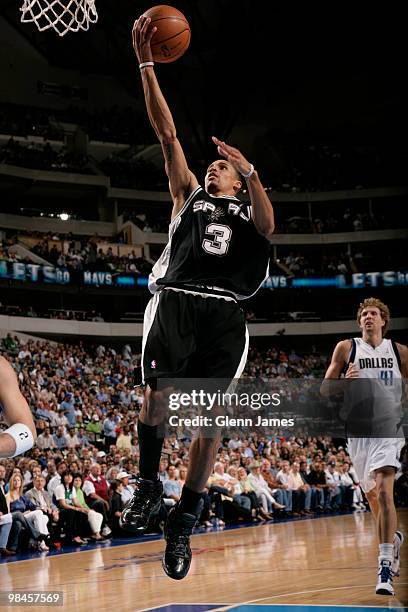 George Hill of the San Antonio Spurs goes in for the layup against the Dallas Mavericks during a game at the American Airlines Center on April 14,...