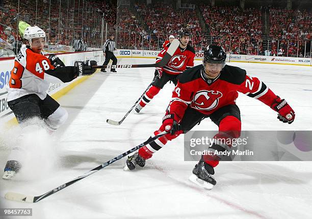 Danny Briere of the Philadelphia Flyers follows through on a shot while being defended by Bryce Salvador of the New Jersey Devils in Game One of the...