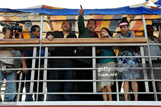 Venezuelan President Hugo Chavez gestures alongside his Nicaraguan counterpart Daniel Ortega from a boat on the Xolotlan lake in Managua on April 14,...