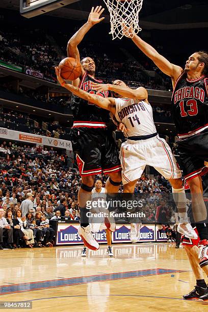 Augustin of the Charlotte Bobcats goes for the layup against Joakim Noah of the Chicago Bulls on April 14, 2010 at the Time Warner Cable Arena in...