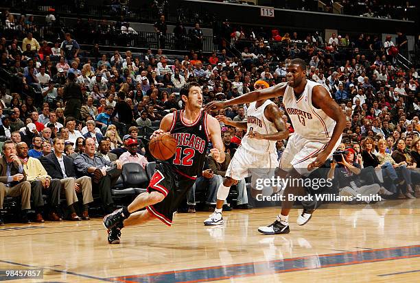 Kirk Hinrich of the Chicago Bulls drives toward the basket against Nazr Mohammed of the Charlotte Bobcats on April 14, 2010 at the Time Warner Cable...
