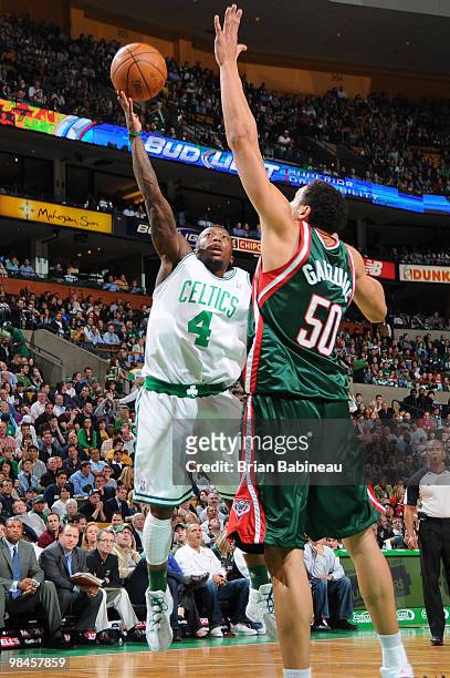Nate Robinson of the Boston Celtics lays the ball up against Dan Gadzuric of the Milwaukee Bucks on April 14, 2010 at the TD Garden in Boston,...