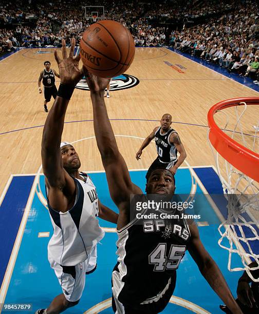 DeJuan Blair of the San Antonio Spurs goes up for the rebound against Brendan Haywood of the Dallas Mavericks during a game at the American Airlines...