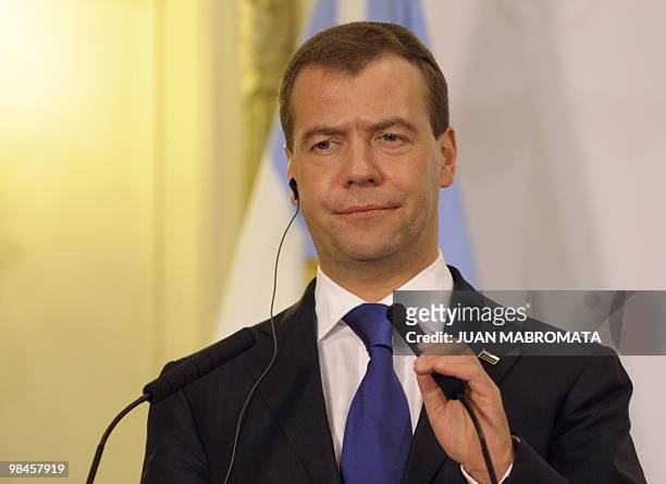 Russian President Dmitry Medvedev gestures during a press conference next to Argentine President Cristina Fernandez de Kirchner after a working...