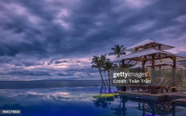 an infinity pool at sunset in maui, hawaii, usa. - oceania stock pictures, royalty-free photos & images