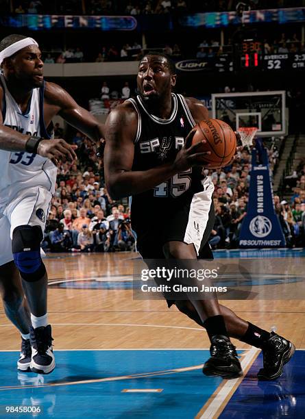 DeJuan Blair of the San Antonio Spurs drives against Brendan Haywood of the Dallas Mavericks during a game at the American Airlines Center on April...